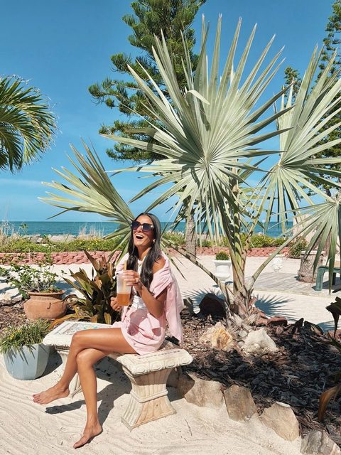 Aneesa laughing by the beach